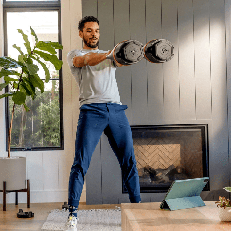 lifestyle image from Bowflex of man working out with two kettlebells