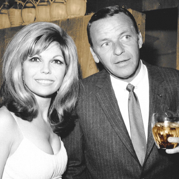 Frank Sinatra enjoys a cocktail at an event with his daughter singer Nancy Sinatra in circa 1967. (Photo by Earl Leaf/Michael Ochs Archives/Getty Images)