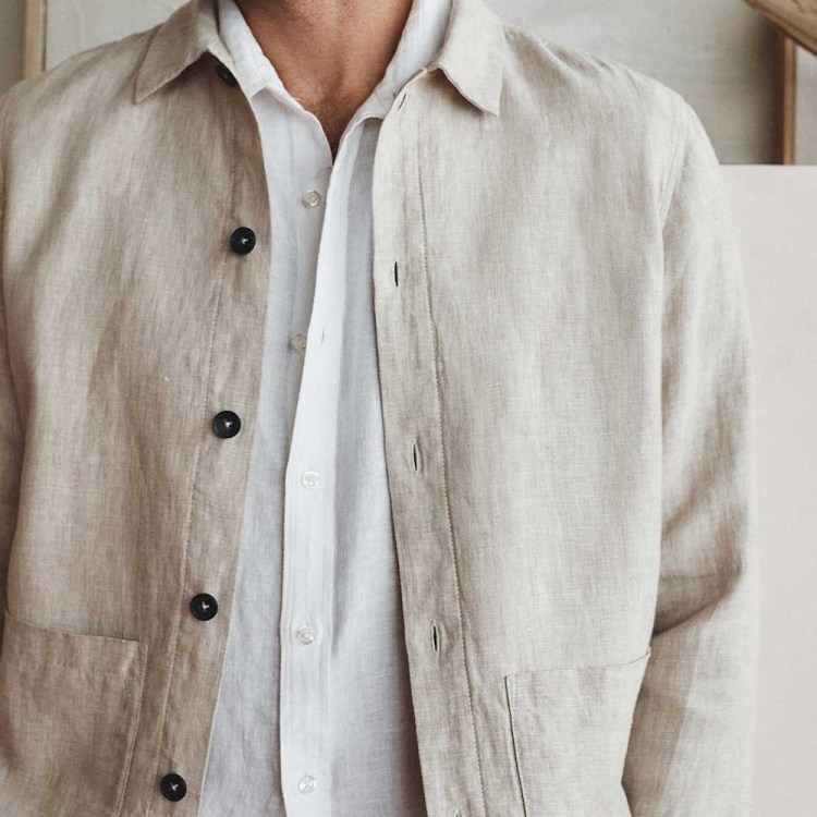 A model wearing a flax-colored Quince linen chore coat