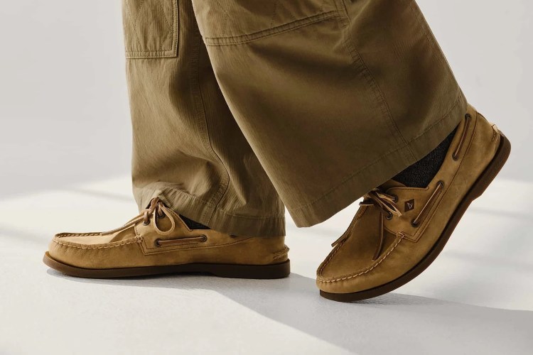 a model in a pair of tan pants and Sperry boat shoes