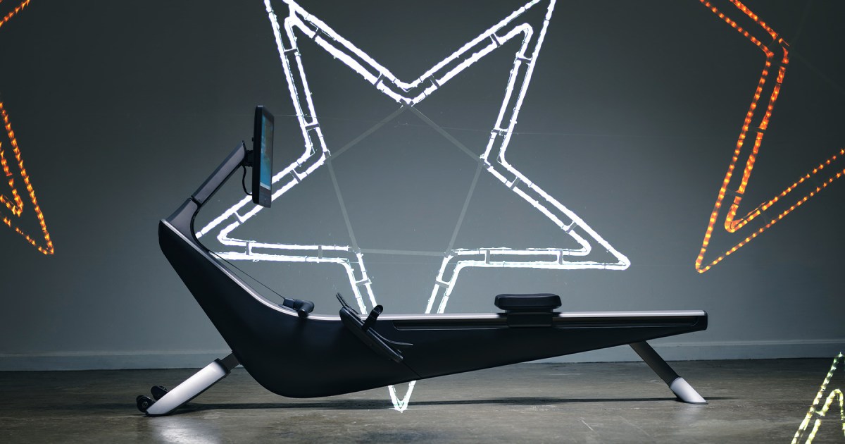 A rowing machine flanked by neon lights in the shape of stars