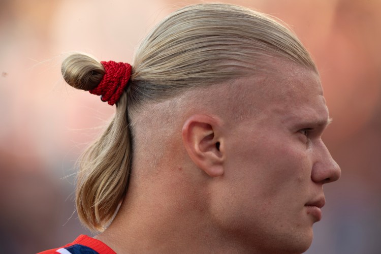 The profile of Norwegian soccer star Erling Haaland with a man bun