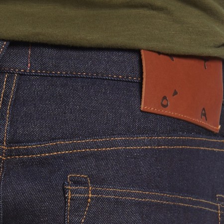 a close-up of selvedge blue jeans from behind