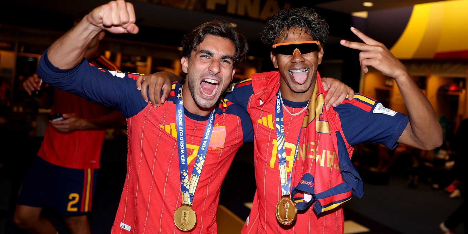 two men in red soccer jerseys cheering