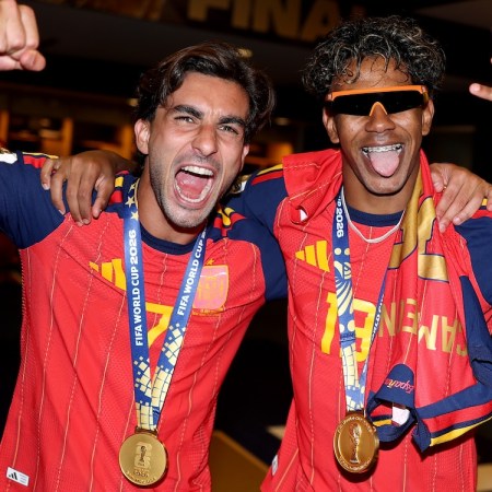 two men in red soccer jerseys cheering