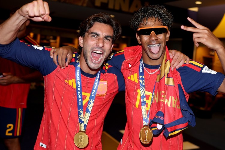 two men in red soccer jerseys cheering