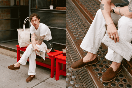 A man sitting with his suede slippers on a red bench.