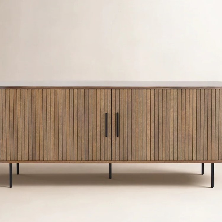 Oval wooden sideboard with vertical slats, two doors, black handles, and thin black legs.