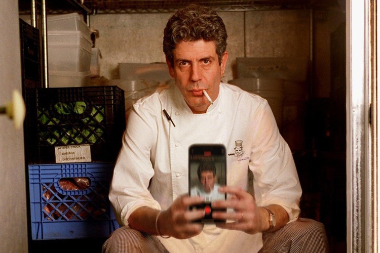 Anthony Bourdain taking a selfie with a cigarette in his mouth