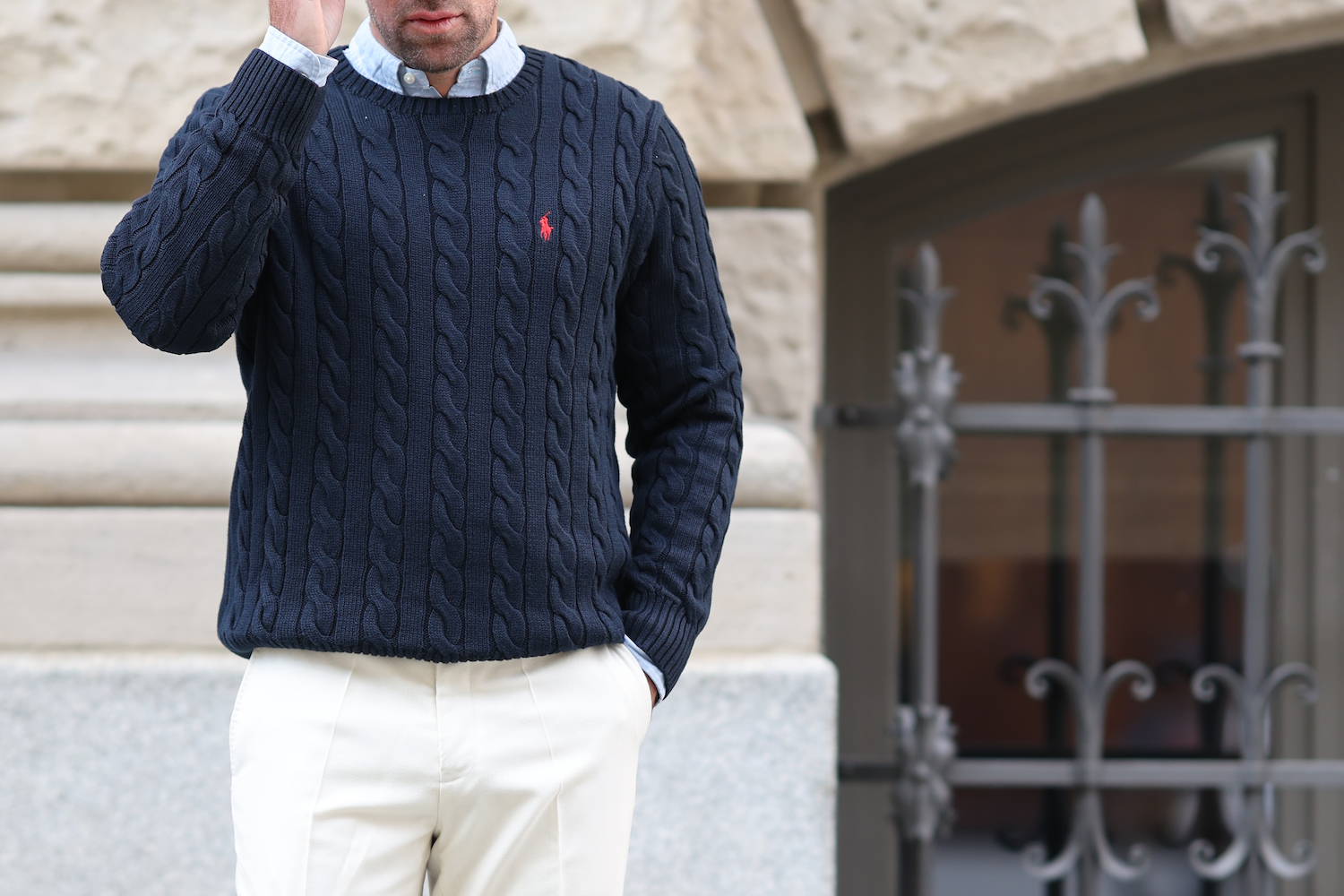 A model in a navy cable-knit Polo Ralph Lauren sweater.