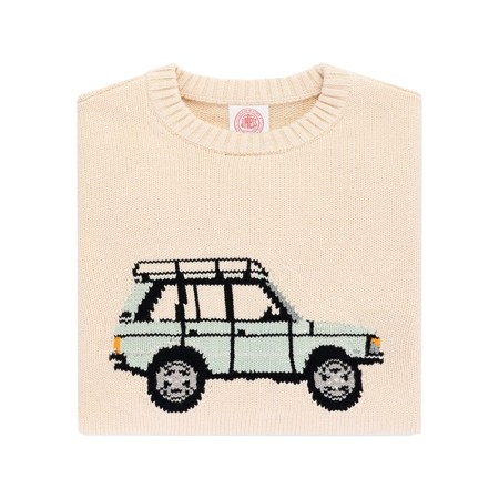 Folded cream sweater with a knitted light blue SUV design featuring a roof rack.