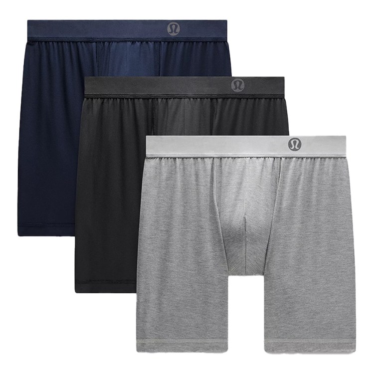 Three pairs of Lululemon boxer briefs in navy, black, and gray, stacked diagonally with waistbands visible.