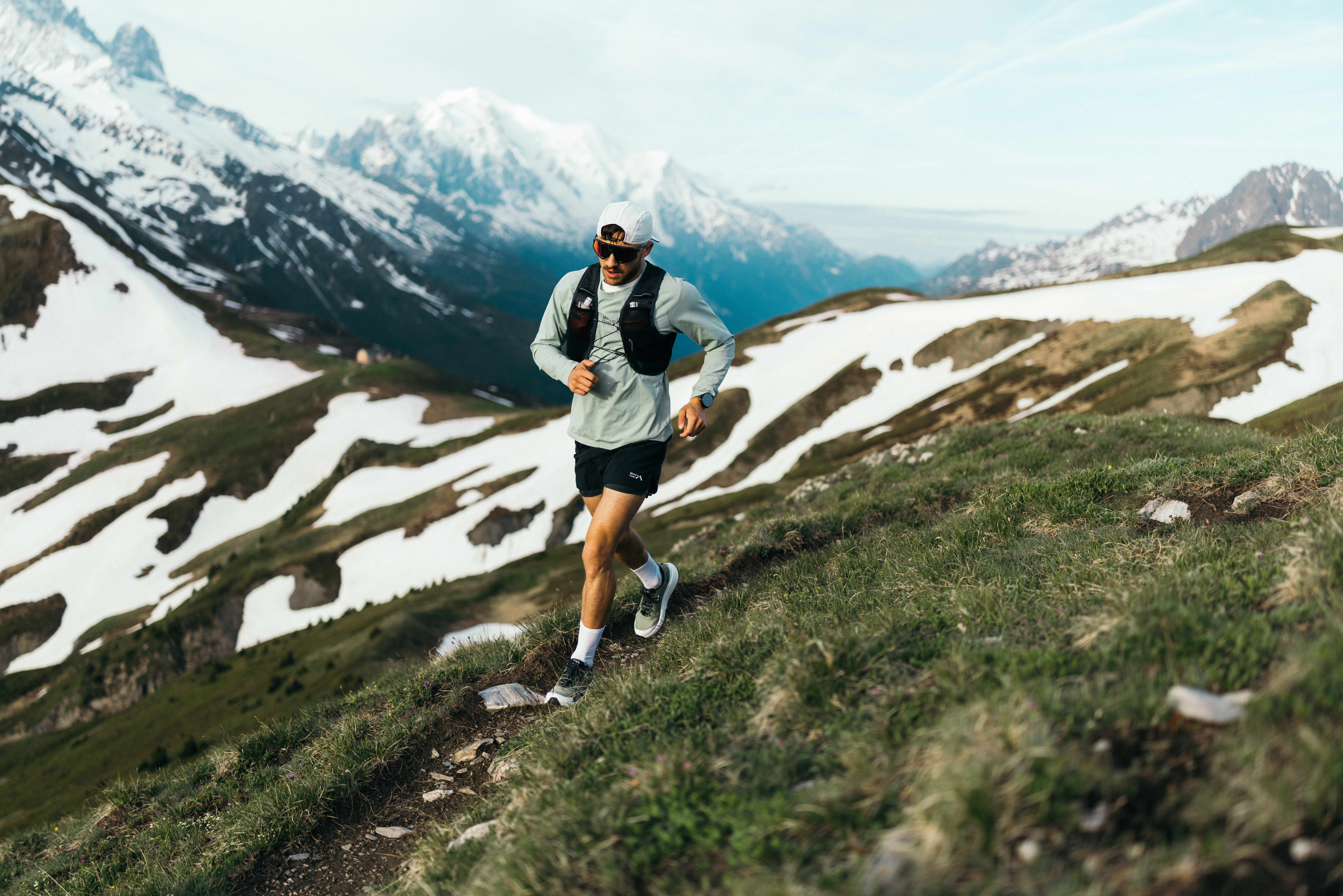 A man running in hiker shoes on a mountain top.