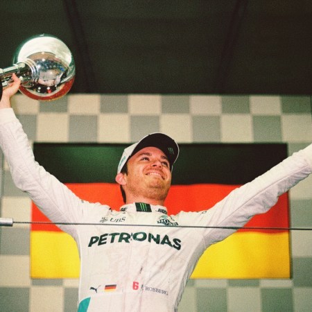 Nico Rosberg in street clothes, waving to the crowd.