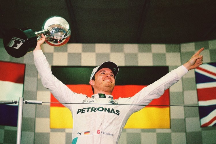 Nico Rosberg in street clothes, waving to the crowd.