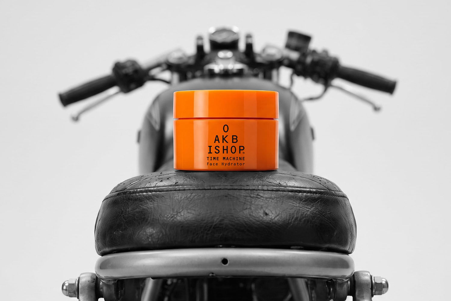 a moisturizer in an orange jar on a motorcylce