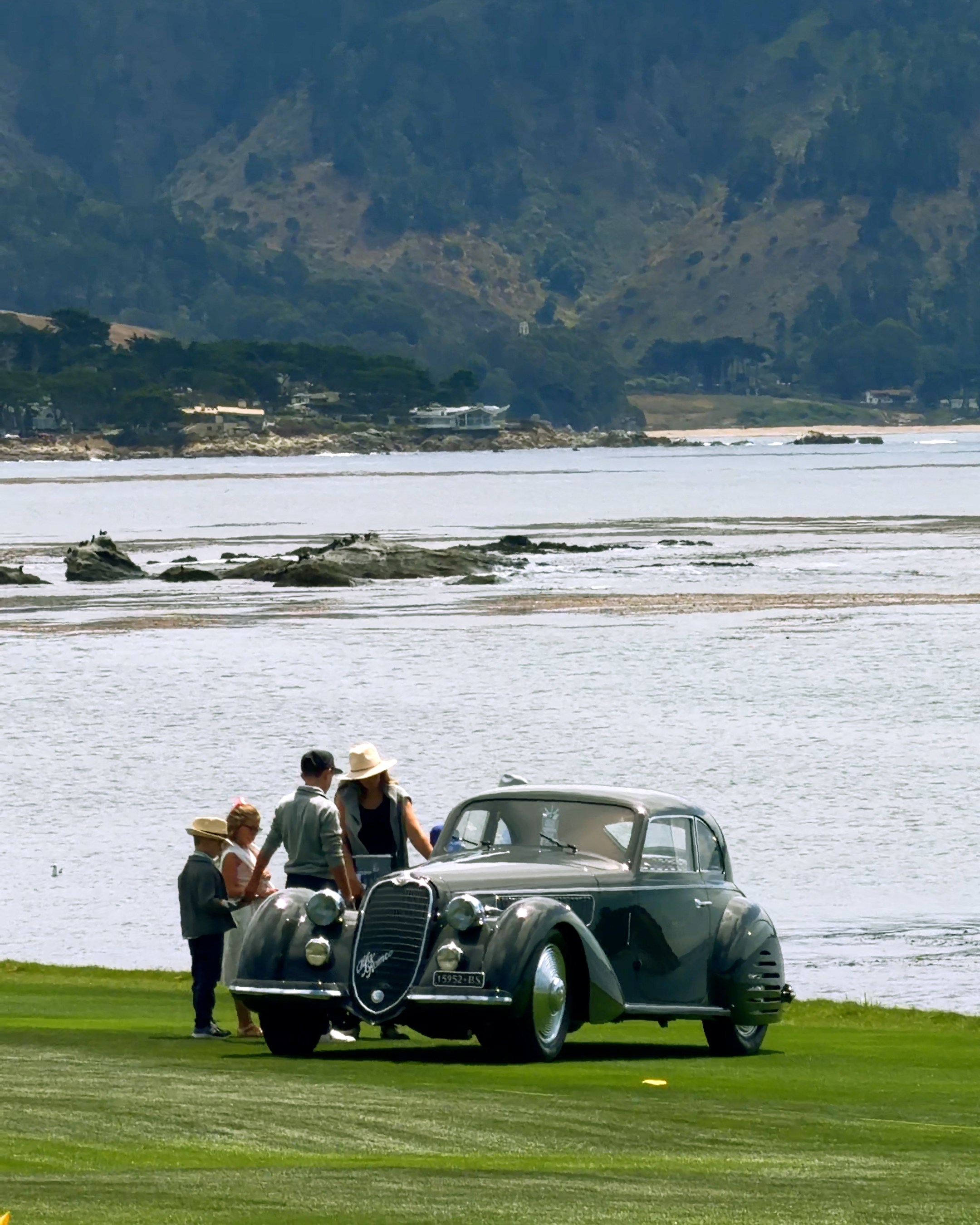 A vintage Alpha Romeo parked on the 18th fairway at Pebble Beach.