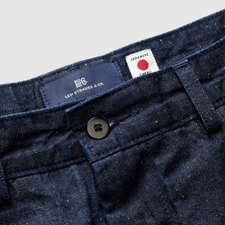 A close-up photo of the waist on a pair of Levi's Blue Tab jeans, with a Levi's label next to a white "Japanese fabric" label with a red dot
