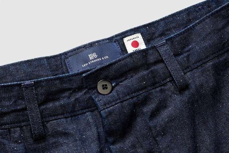 A close-up photo of the waist on a pair of Levi's Blue Tab jeans, with a Levi's label next to a white "Japanese fabric" label with a red dot