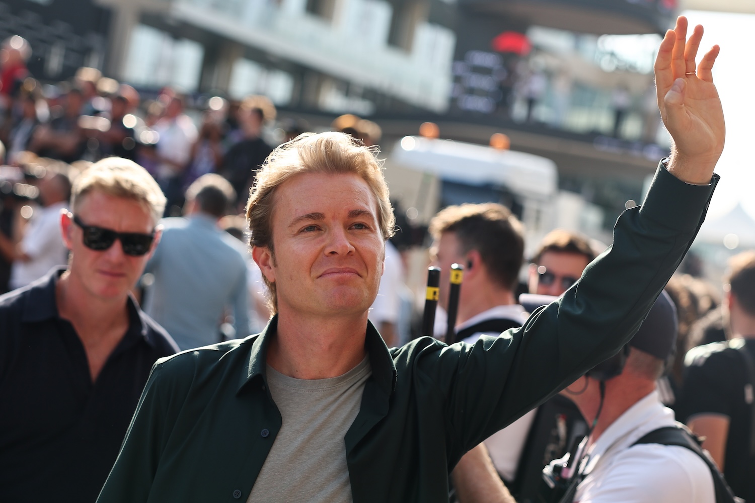Nico Rosberg in street clothes, waving to the crowd.