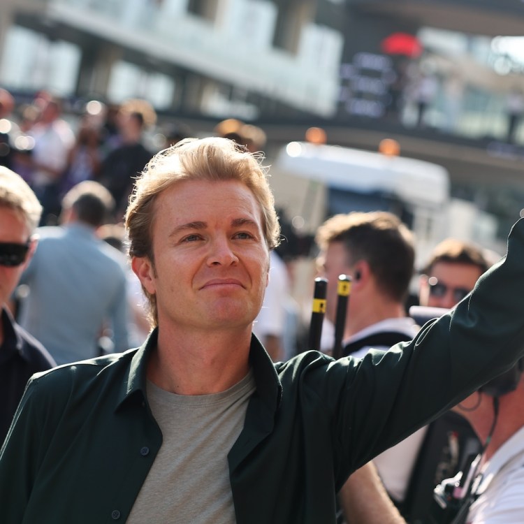 Nico Rosberg in street clothes, waving to the crowd.