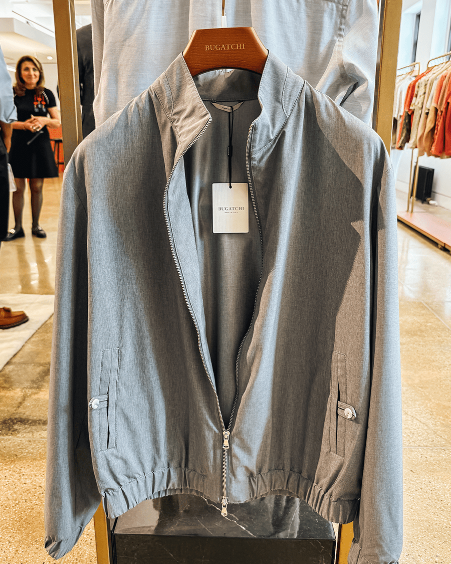 Gray jacket hanging on wooden hanger
