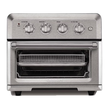 A stainless steel Cuisinart air fryer toaster oven with four control dials and a wire basket inside.