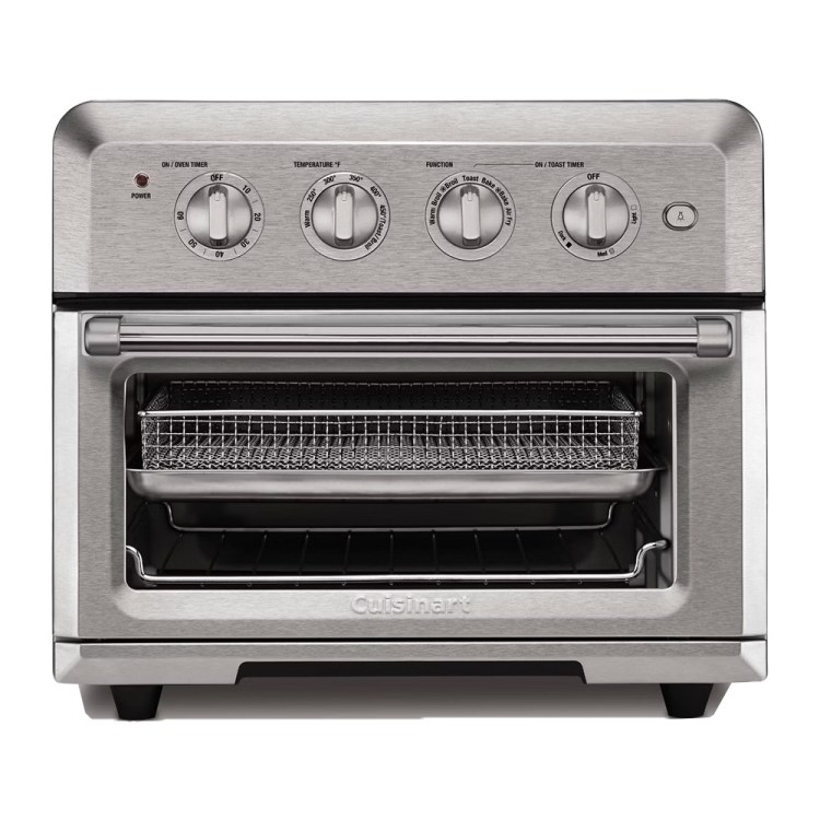 A stainless steel Cuisinart air fryer toaster oven with four control dials and a wire basket inside.