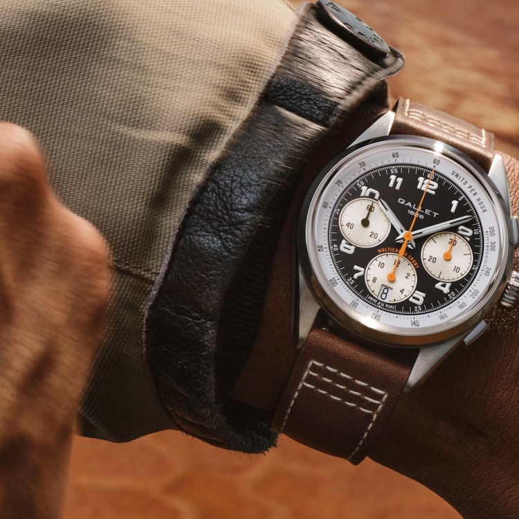 Wrist wearing a Gallet 1826 Multichron Sport watch with a black face, white subdials, and a brown leather strap.