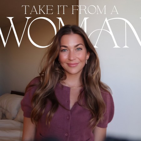 Smiling woman with long brown hair in a pink cardigan, with "TAKE IT FROM A WOMAN" text overlay.
