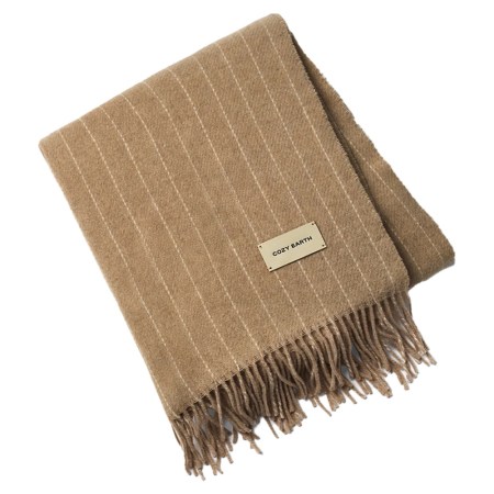 Folded tan blanket with thin white pinstripes, fringe on one end, and a "COZY EARTH" label.
