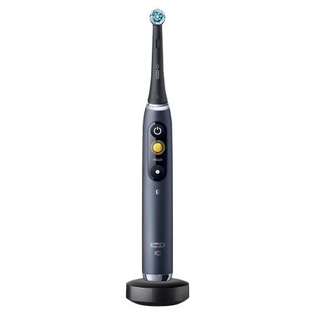 Oral-B iO Series 9 electric toothbrush in black, with a blue-bristled head, on its charging base.