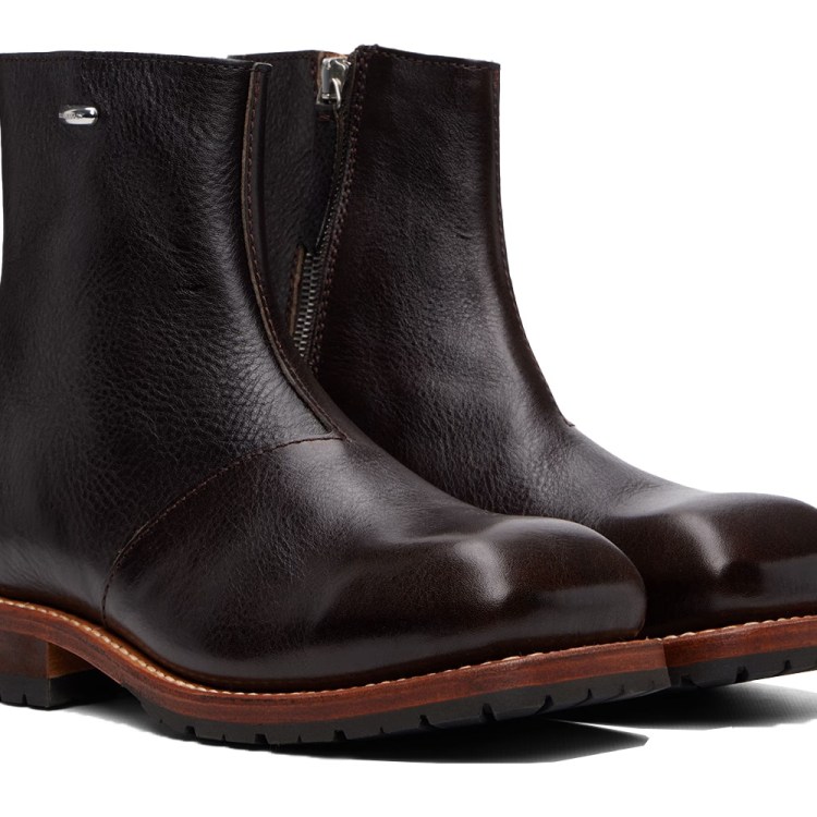 Pair of dark brown leather ankle boots with zippers on the inner sides and light brown soles.