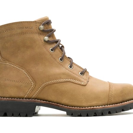 A single tan leather Wolverine 1000 Mile boot with brown laces, a cap toe, and a black lug sole.